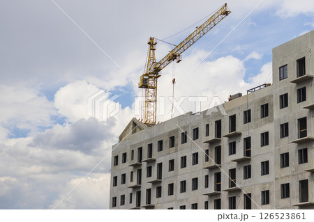 Industrial crane next to the building under construction 126523861