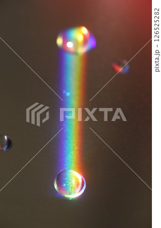 Rainbow is reflected in a puddle of water Rainbow is reflected in a puddle of water 126525282