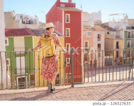 Woman strolls through colorful streets of Spanish coastal town Woman strolls through colorful streets of Spanish coastal town 126527635
