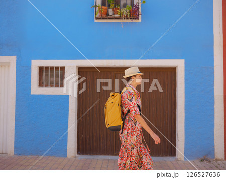 Woman strolls through colorful streets of Spanish coastal town Woman strolls through colorful streets of Spanish coastal town 126527636