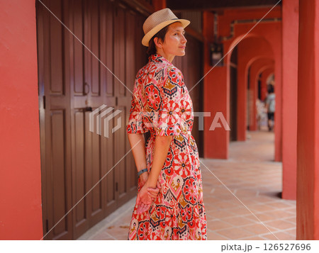 woman in dress and hat exploring vibrant streets of Malacca, Malaysia. woman in dress and hat exploring vibrant streets of Malacca, Malaysia. 126527696