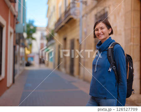 woman strolling through charming narrow streets of Denia, 126527709