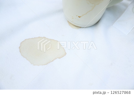 dirty coffee stain on shirt from drinking in freetime. stain for cleaning concept dirty coffee stain on shirt from drinking in freetime. stain for cleaning concept 126527868