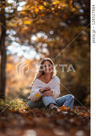 Woman Selfie Phone Autumn Park - Young woman takes a selfie with her smartphone while enjoying the fall scenery in a park. Woman Selfie Phone Autumn Park - Young woman takes a selfie with her smartphone while enjoying the fall scenery in a park. 126527884