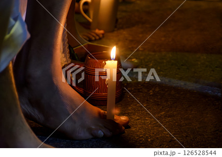 Bare feet holding a candle 126528544