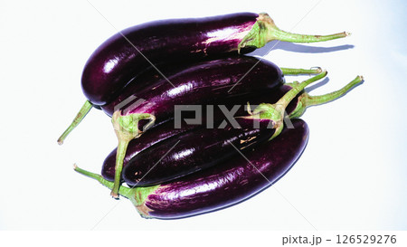 Pile Fresh purple eggplant on a white background. Summer vegetable. Pile Fresh purple eggplant on a white background. Summer vegetable. 126529276