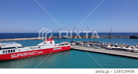 Bari, Italy - May 10, 2025: Aerial view of a Superfast Ferry. It is a Greece-based ferry company. The ship is anchored in the port of the Apulian city. Bari, Italy - May 10, 2025: Aerial view of a Superfast Ferry. It is a Greece-based ferry company. The ship is anchored in the port of the Apulian city. 126529436
