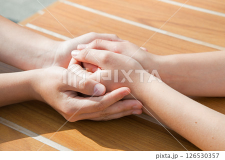Close-up view of comforting hands Close-up view of comforting hands 126530357