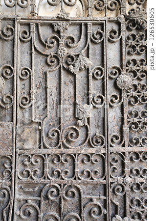 detail of an old entrance door of a finely decorated building in Tbilisi, Georgia. 126530605