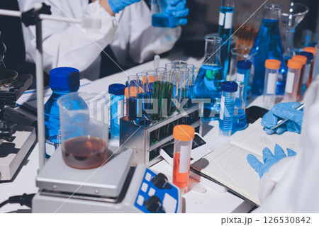 Scientist pipetting medical samples into microplate in laboratory Scientist pipetting medical samples into microplate in laboratory 126530842