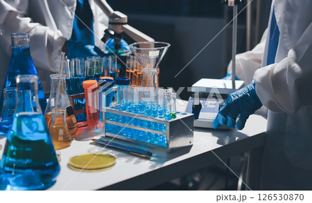 Scientist pipetting medical samples into microplate in laboratory Scientist pipetting medical samples into microplate in laboratory 126530870