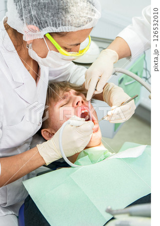 Dental procedure during an examination with a young patient in a modern clinic setting 126532010