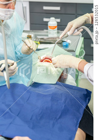 Dental procedure in a modern clinic focusing on patient care and advanced technology Dental procedure in a modern clinic focusing on patient care and advanced technology 126532015