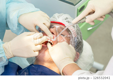 Dental cleaning procedure in a clinic with focus on plaque removal and teeth whiteness Dental cleaning procedure in a clinic with focus on plaque removal and teeth whiteness 126532041