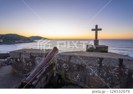 Defensive Cannon and Cross Overlooking Baiona Bay Sunset. Defensive Cannon and Cross Overlooking Baiona Bay Sunset. 126532079