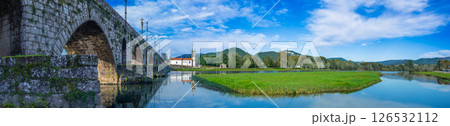 Ancient stone bridge and Saint Anthony church reflected in calm river, Portugal. Ancient stone bridge and Saint Anthony church reflected in calm river, Portugal. 126532112