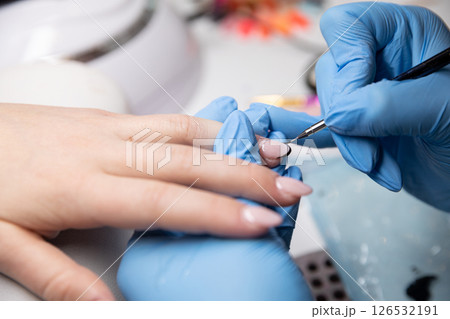 Skillfully applied professional nail art services provided by a trained technician expert 126532191