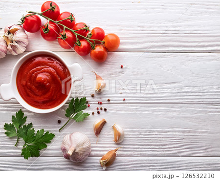 Bowl with tasty tomato paste and fresh vegetables on light wooden background. Salsa sauce and ingredients. AI Generated. 126532210