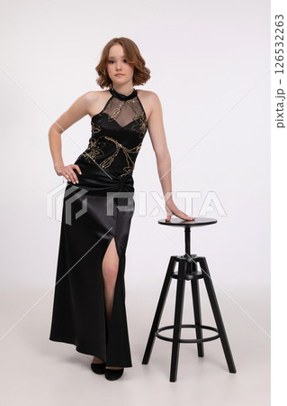 An Elegant Young Woman Dressed in a Chic and Stylish Black Dress Posing with Confidence An Elegant Young Woman Dressed in a Chic and Stylish Black Dress Posing with Confidence 126532263