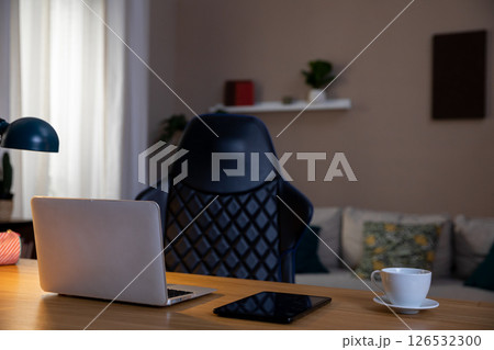A modern home office featuring a laptop, creates a cozy and inviting atmosphere for productivity A modern home office featuring a laptop, creates a cozy and inviting atmosphere for productivity 126532300