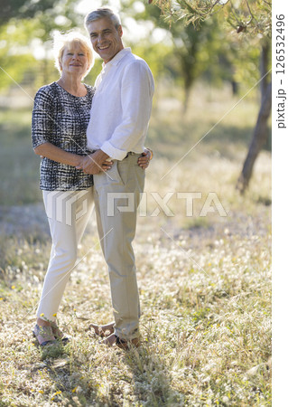 Happy senior couple embracing in sunny summer nature 126532496