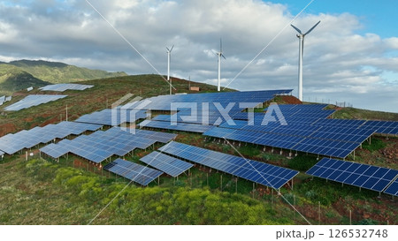Solar energy panels photovoltaic cell and wind power plants on the seashore landscape for production of renewable green energy 126532748