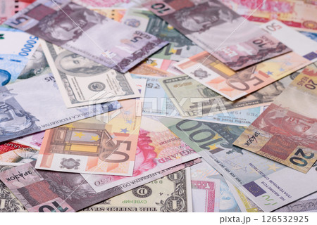 A background consisting of paper banknotes of different currencies A background consisting of paper banknotes of different currencies 126532925