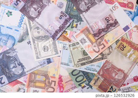 A background consisting of paper banknotes of different currencies A background consisting of paper banknotes of different currencies 126532926