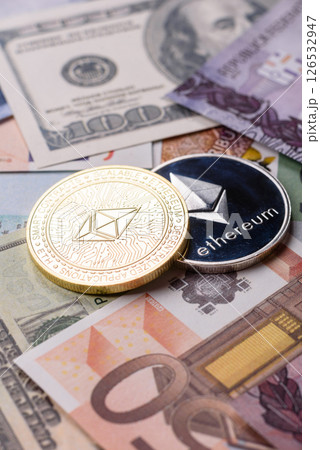 Round metal ethereum on a background of paper banknotes 126532947