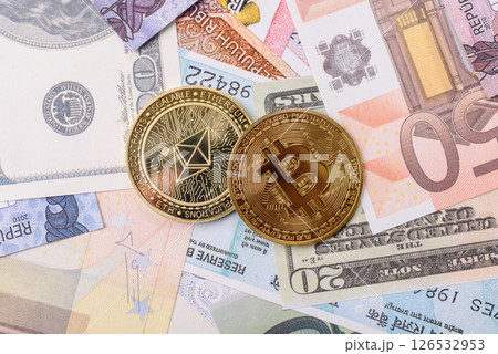 Round metal ethereum on a background of paper banknotes 126532953