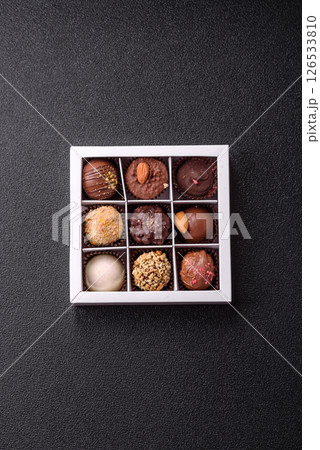Homemade chocolate candies with different fillings and sprinkles 126533810