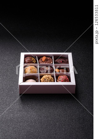 Homemade chocolate candies with different fillings and sprinkles 126533811