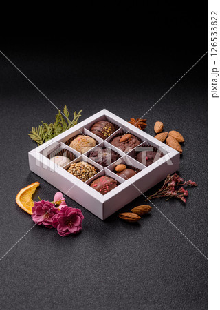 Homemade chocolate candies with different fillings and sprinkles Homemade chocolate candies with different fillings and sprinkles 126533822