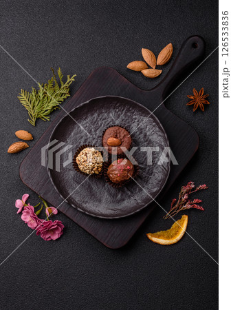 Homemade chocolate candies with different fillings and sprinkles 126533836