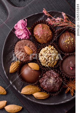 Homemade chocolate candies with different fillings and sprinkles 126533844