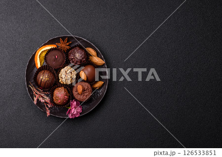 Homemade chocolate candies with different fillings and sprinkles Homemade chocolate candies with different fillings and sprinkles 126533851