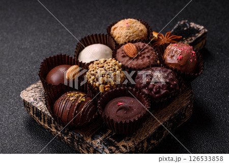 Homemade chocolate candies with different fillings and sprinkles Homemade chocolate candies with different fillings and sprinkles 126533858