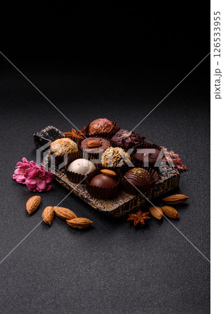 Homemade chocolate candies with different fillings and sprinkles Homemade chocolate candies with different fillings and sprinkles 126533955