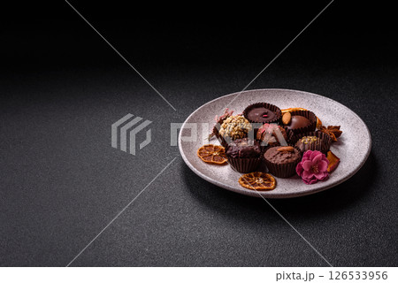 Homemade chocolate candies with different fillings and sprinkles 126533956