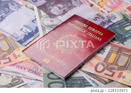 International passport of a citizen of Italy on background of paper banknotes International passport of a citizen of Italy on background of paper banknotes 126533975