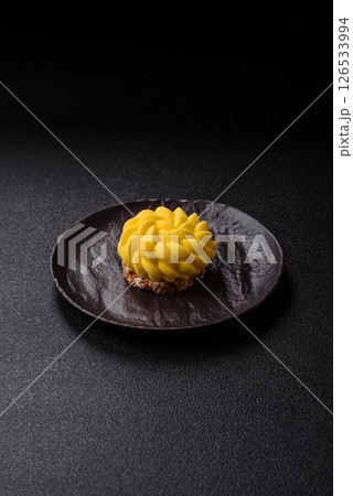 Round sweet tart of yellow color with citrus and passion fruit flavor 126533994