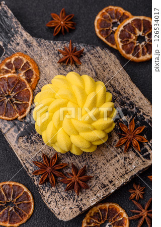 Round sweet tart of yellow color with citrus and passion fruit flavor 126534017