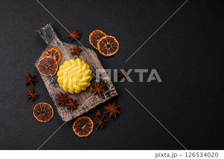Round sweet tart of yellow color with citrus and passion fruit flavor 126534020