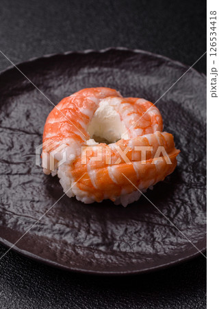 Donut shaped sushi rolls with salmon, shrimp and tuna 126534418