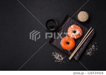 Donut shaped sushi rolls with salmon, shrimp and tuna 126534428