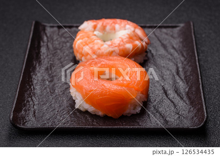 Donut shaped sushi rolls with salmon, shrimp and tuna 126534435