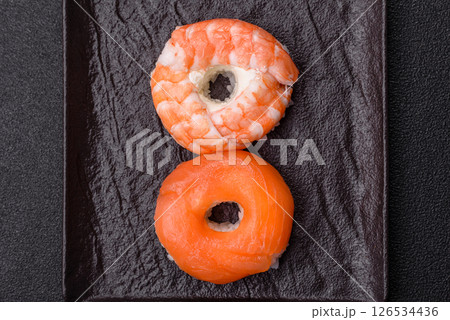 Donut shaped sushi rolls with salmon, shrimp and tuna 126534436