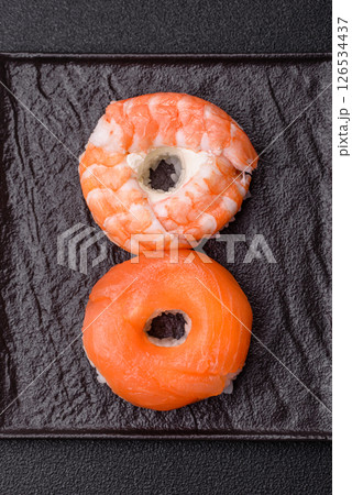 Donut shaped sushi rolls with salmon, shrimp and tuna 126534437
