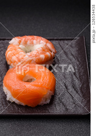 Donut shaped sushi rolls with salmon, shrimp and tuna 126534438