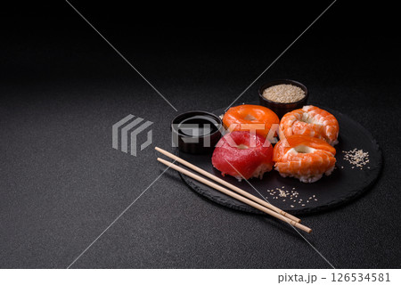 Donut shaped sushi rolls with salmon, shrimp and tuna 126534581